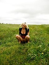 Gorgeous busty blonde filmed pissing on a field